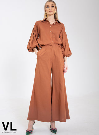 VL The Label by Virgos Lounge. Cropped wide leg trousers with chunky gold buttons and pockets in tan. Matching shirt available, with puffy sleeves and chunky gold buttons. Styled with Virgos Lounge Zoie Earrings and Virgos Lounge Shoes.